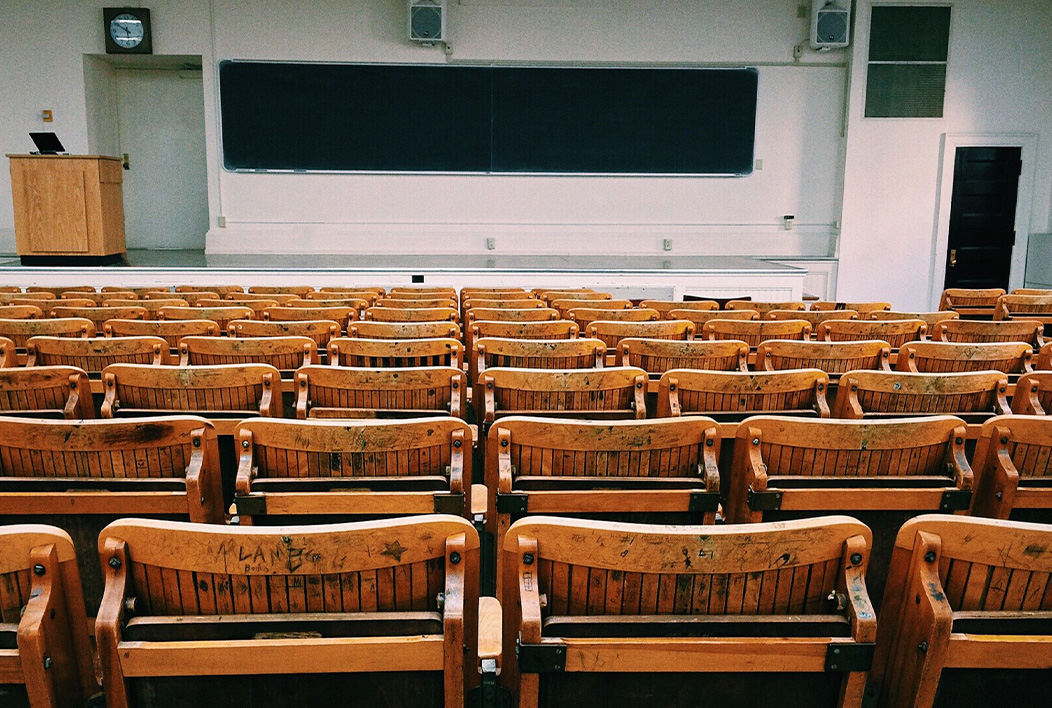 College Classroom with wooden seats facing the front of the classroom