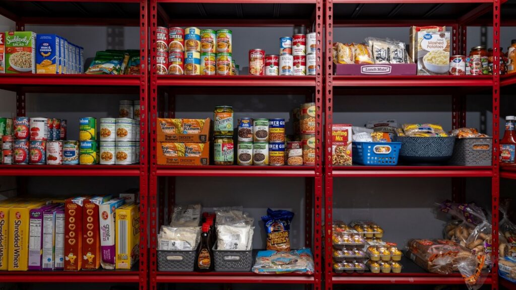 Shelves of food including canned and boxed goods and snacks.