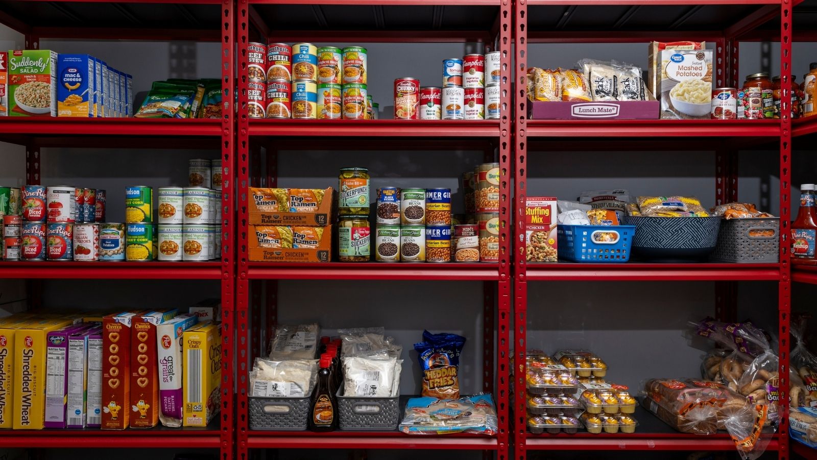 Shelves of food including canned and boxed goods and snacks.