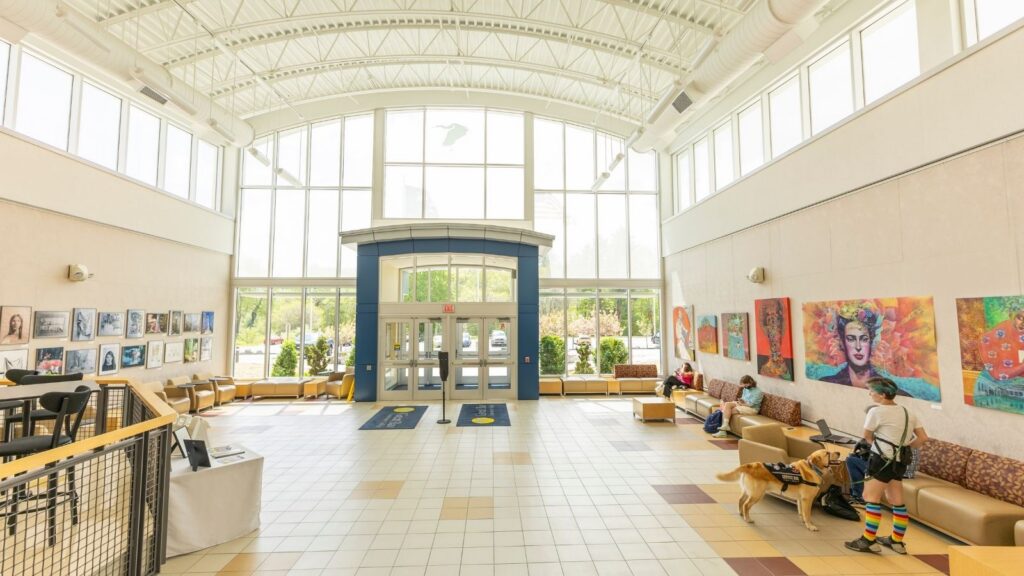 The interior of a brightly lit building, featuring colorful art on the walls