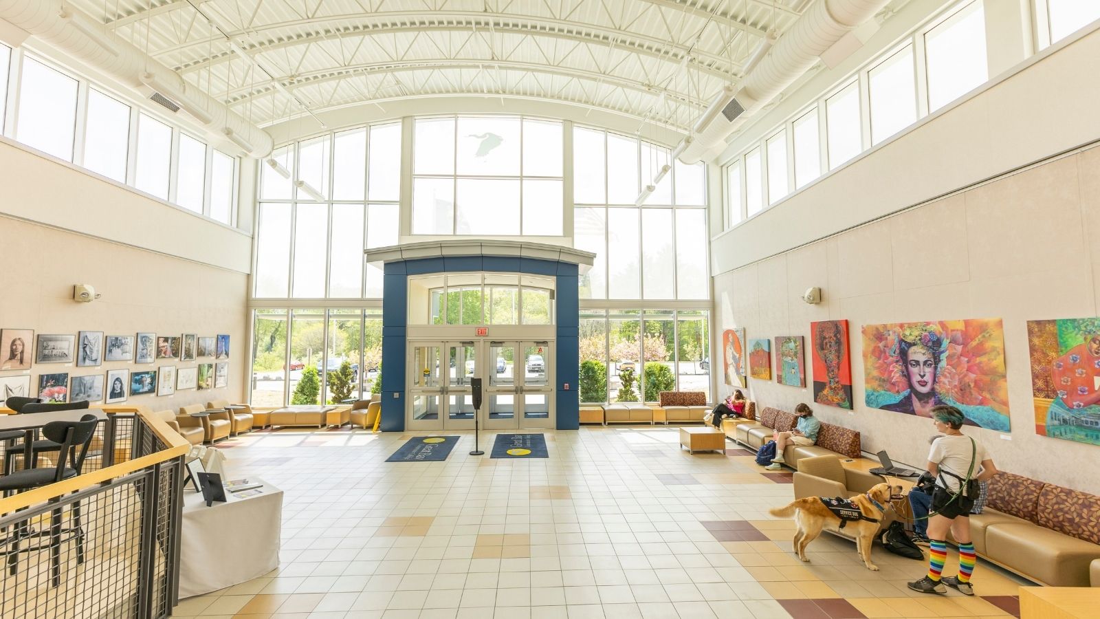 The interior of a brightly lit building, featuring colorful art on the walls
